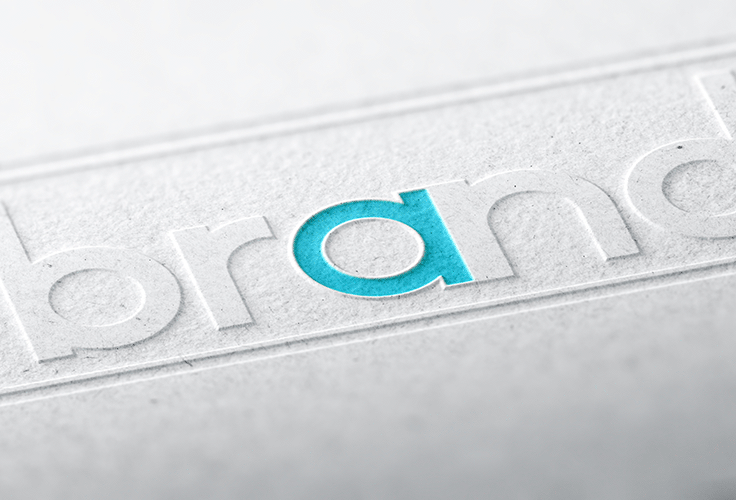 The word 'brand' embossed on a white surface, with a blue letter 'a'.